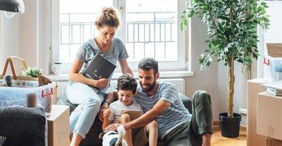 family-in-living-room-with-moving-boxes