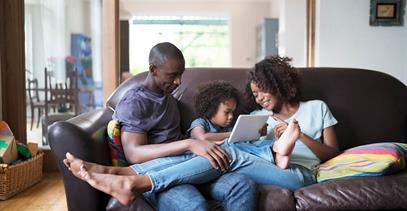 young-family-sitting-on-couch-together