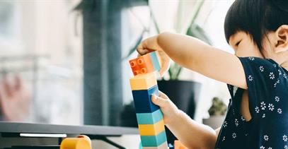 little-girl-stacking-legos