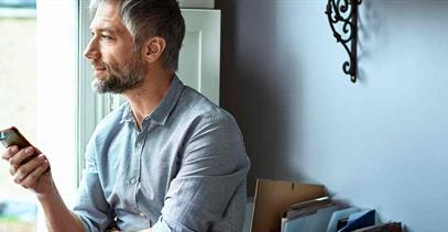 older-gentleman-using-cell-phone-in-home-office