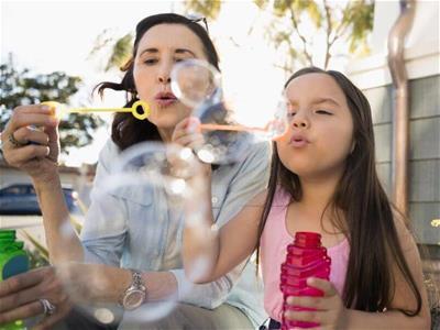 Mom and child blowing bubbles